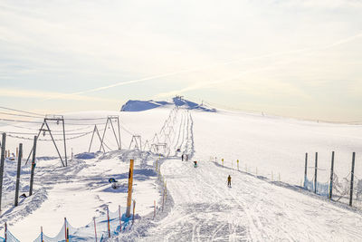 Scenic view of snow covered land against sky