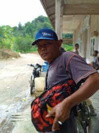 Side view of young man standing on road