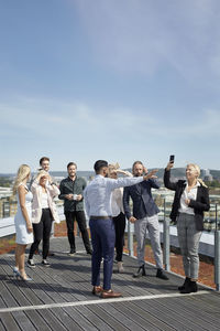 Group of people standing against the sky