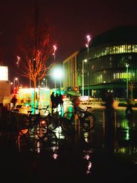 Men in illuminated city at night