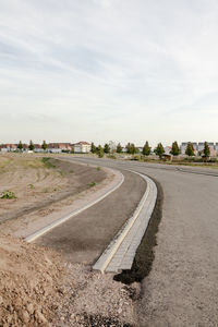 Road by landscape against sky