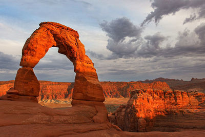 Red rock arch in the golden light of sunset. 