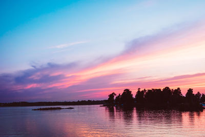 Scenic view of lake against romantic sky at sunset