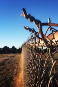 Close-up of barbed wire against clear sky