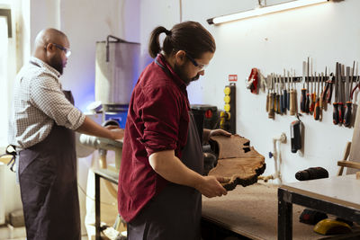 Rear view of people working at office