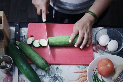 High angle view of hands cutting vegetables