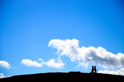 Low angle view of silhouette built structure against sky