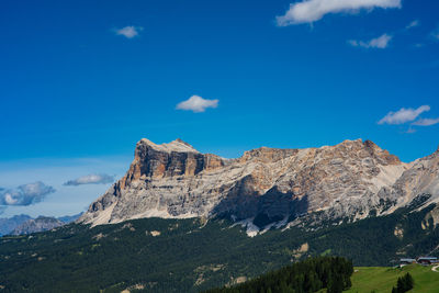 Low angle view of mountain range against blue sky