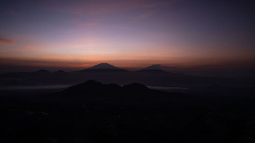 Scenic view of mountains against sky during sunset