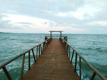 Pier over sea against sky