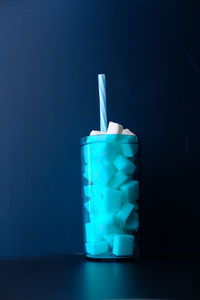 Close-up of wine glass against blue background