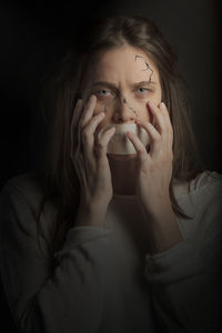 Portrait of a woman drinking water