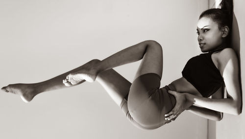 Young woman looking away against white background