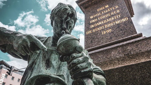 Low angle view of statue against building