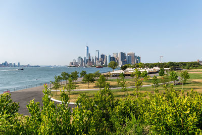 Scenic view of city and buildings against clear sky