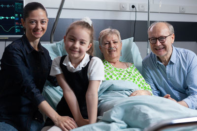 Portrait of business people sitting on bed