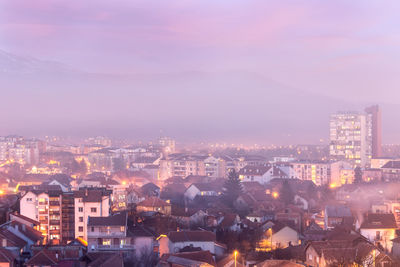 High angle shot of illuminated cityscape against sky at dusk