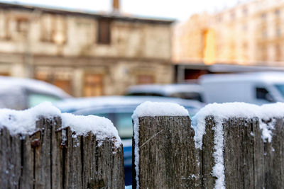 Close-up of icicles on wooden fence during winter