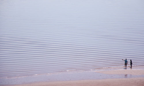 High angle view of couple standing on beach