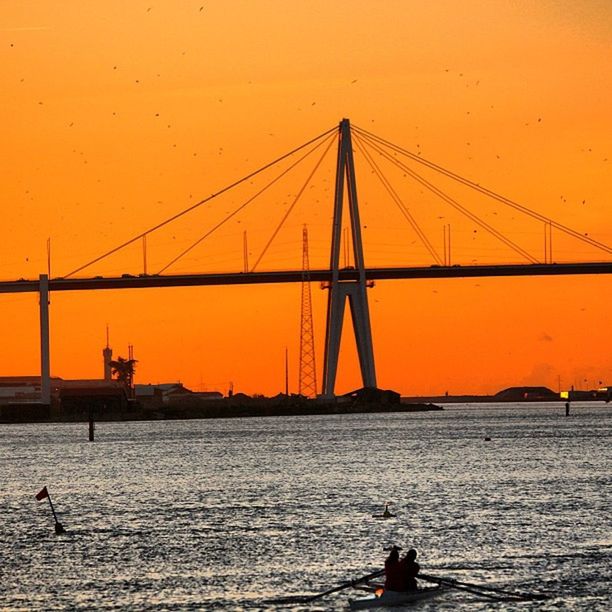 sunset, water, sea, nautical vessel, transportation, silhouette, men, orange color, boat, leisure activity, lifestyles, mode of transport, nature, sky, beauty in nature, built structure, fishing