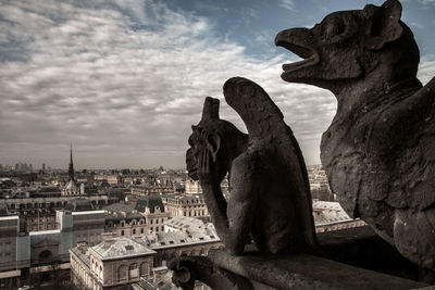 Statue of liberty against sky in city