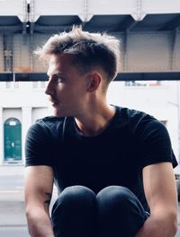 Portrait of young man sitting outdoors