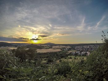 Scenic view of field against sky during sunset