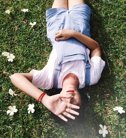 High angle view of woman lying on grass