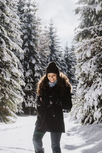 Full length of woman standing on snow covered land