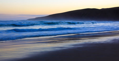 Scenic view of sea against sky during sunset