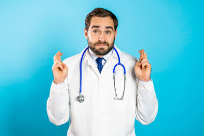 Full length of man standing against blue background