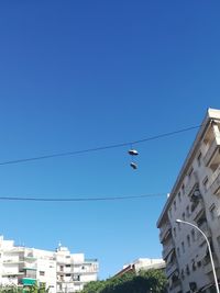 Low angle view of buildings against clear blue sky