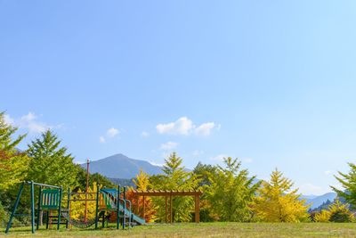 Houses and trees against blue sky