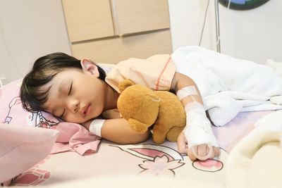 Cute baby girl sleeping on bed at home