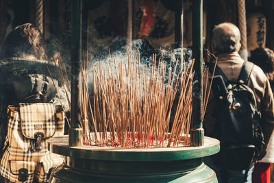 Midsection of man preparing food in temple