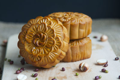 Close-up of moon cakes with seeds on cutting board