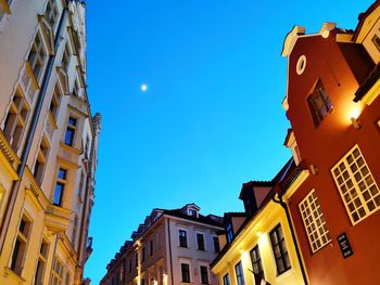 Low angle view of buildings against blue sky