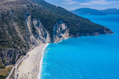 Scenic view of sea and mountains against sky