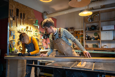 Rear view of man working at workshop