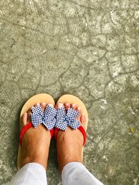 Low section of woman standing in water