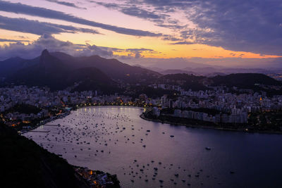 High angle view of city by river against sky