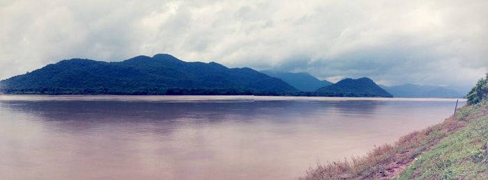 Scenic view of calm sea against cloudy sky