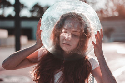 Young woman wearing glass helmet in head during sunny day