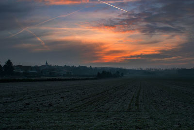 Scenic view of field against sky during sunset