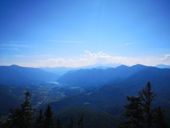 Scenic view of mountains against blue sky