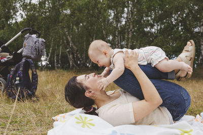 Mother playing with cute girl in park