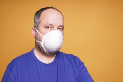 Person with face mask or dust mask or filtering facepiece - virus outbreak or air pollution concept
