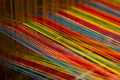 Full frame shot of multi colored threads in factory
