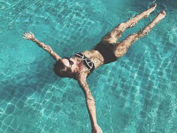 High angle view of young woman swimming in pool