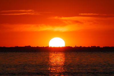 Scenic view of sea against romantic sky at sunset